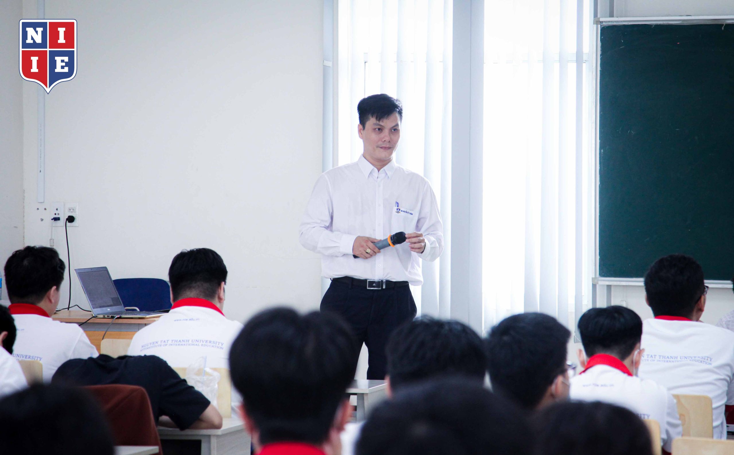 Dr. Tran Son Hai cheerfully observes the class while an AI Voice takes on some of his tasks.